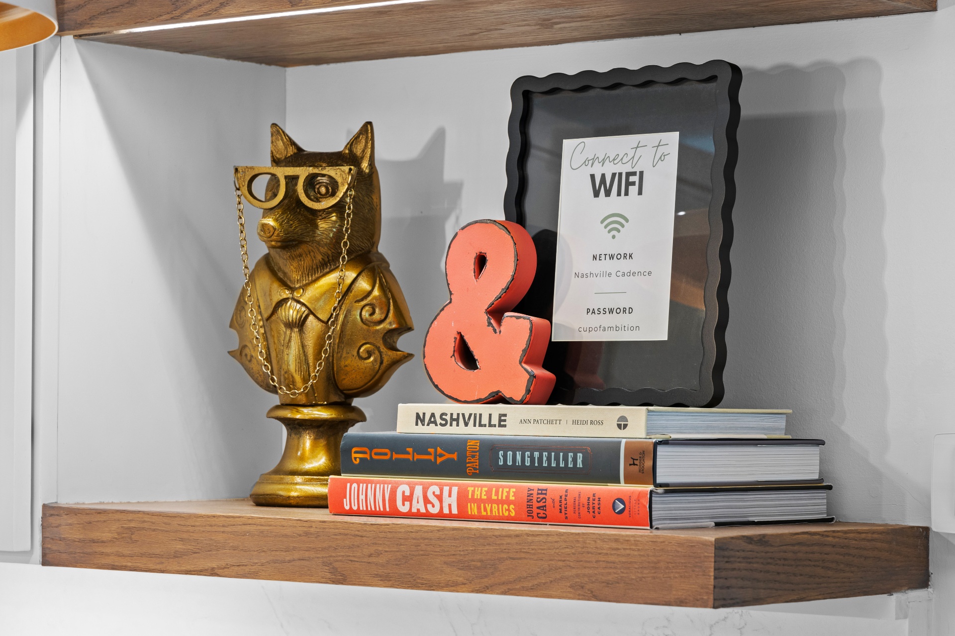 Styled shelf with a brass fox bust and books in a Nashville guest house short-term rental