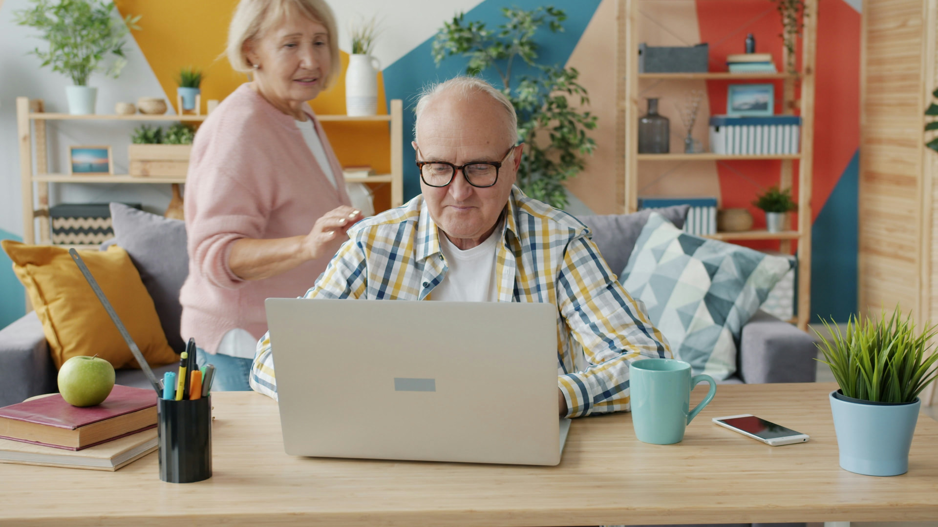 A couple reviewing their Nashville short-term rental details on a laptop at home