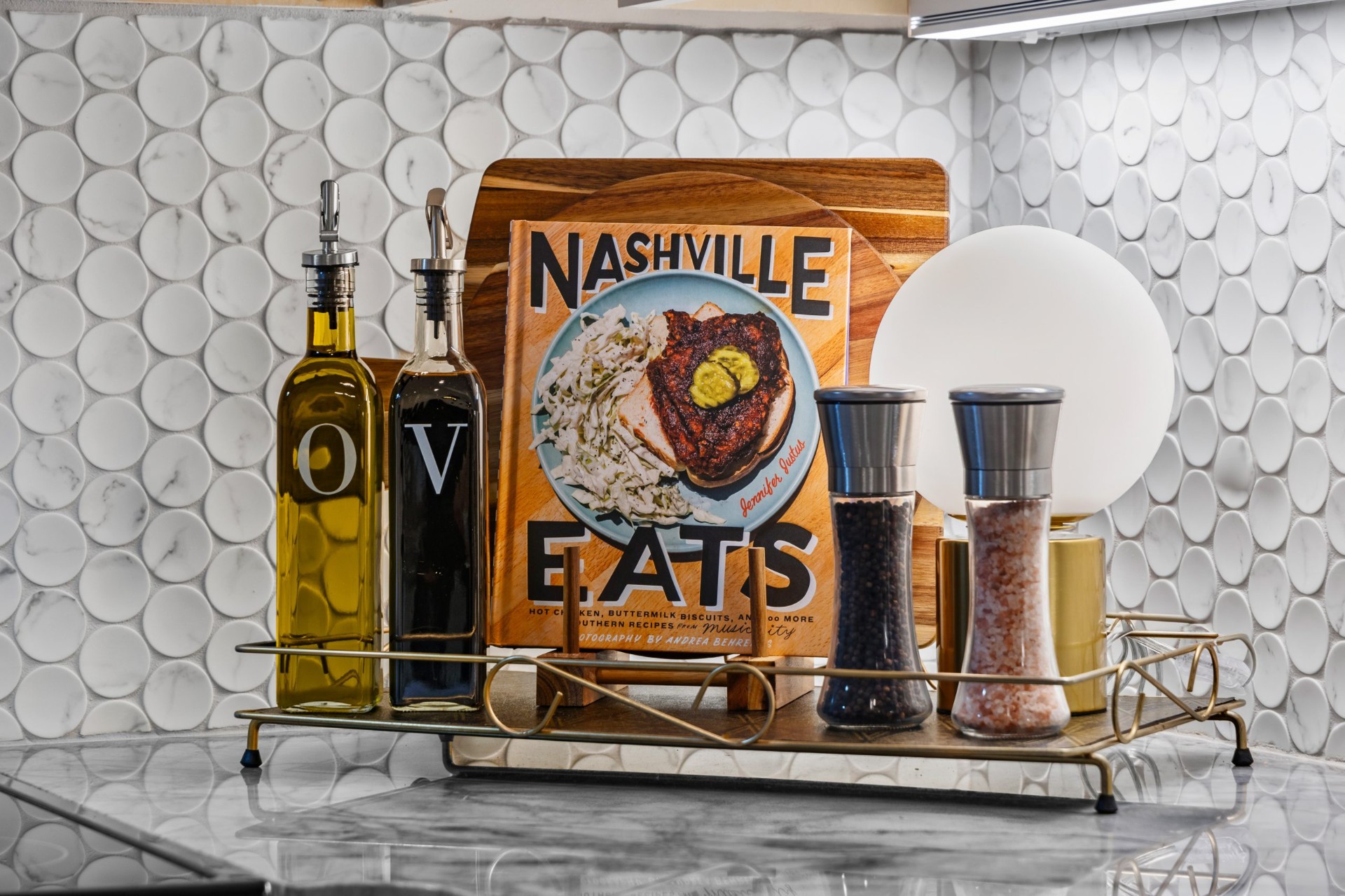 Kitchen counter styled with a cookbook and oil bottles in a Nashville DADU short-term rental